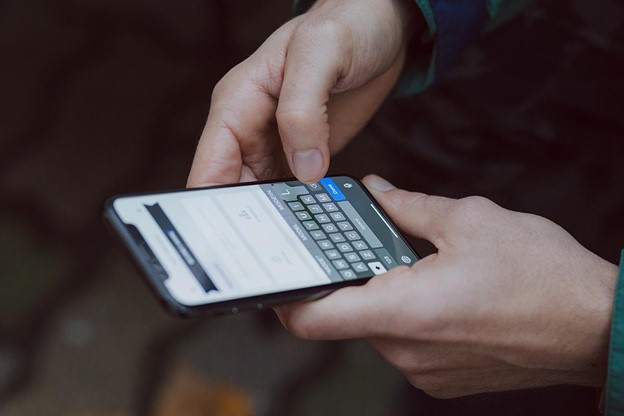 selective focus photography of person using smartphone